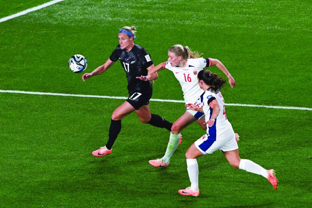 
New Zealand’s forward Hannah Wilkinson (left) controls the ball past Norway’s defender Mathilde Harviken (centre) during their Group A match in Auckland. (AFP) 
