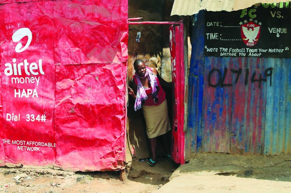 
A woman looks out the door as supporters of Kenya’s opposition leader Raila Odinga protest in Nairobi. 