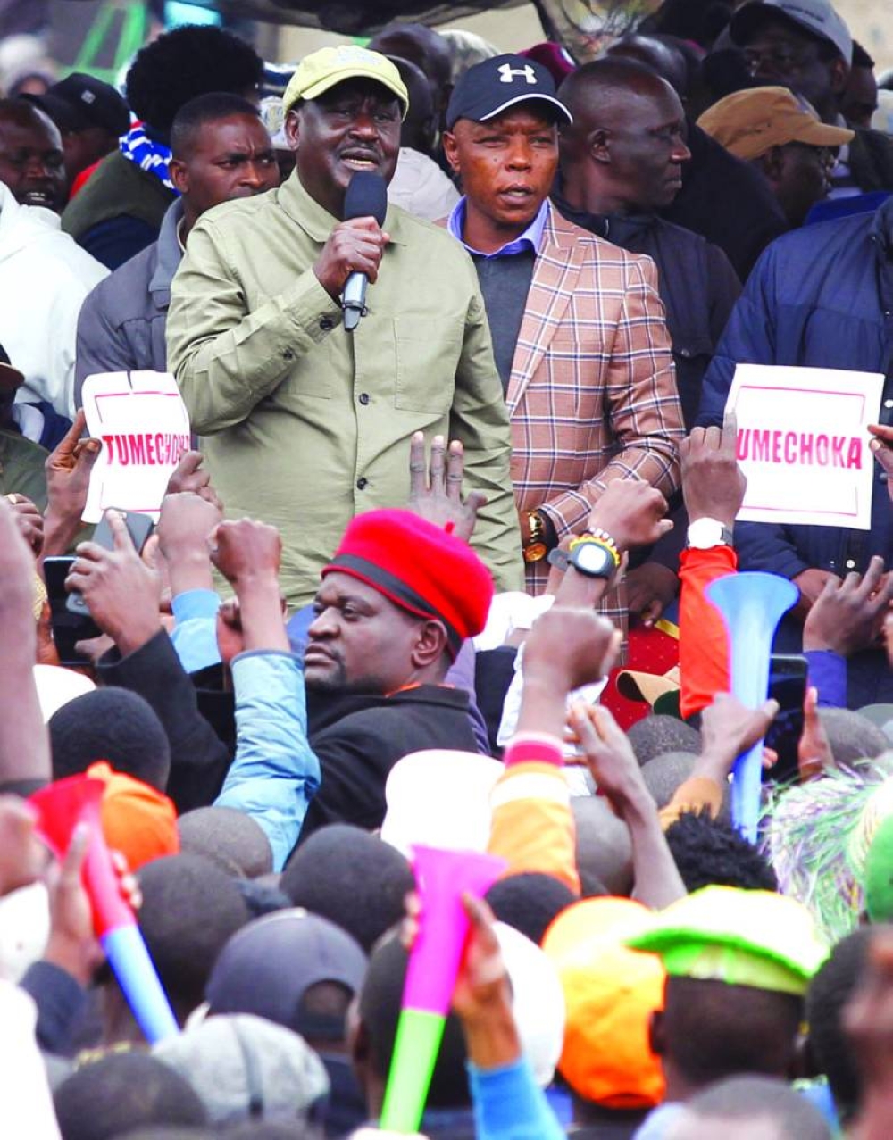 Odinga with former Mungiki criminal gang leader Maina Njenga as he addresses a rally at the Kamukunji grounds in Nairobi.
