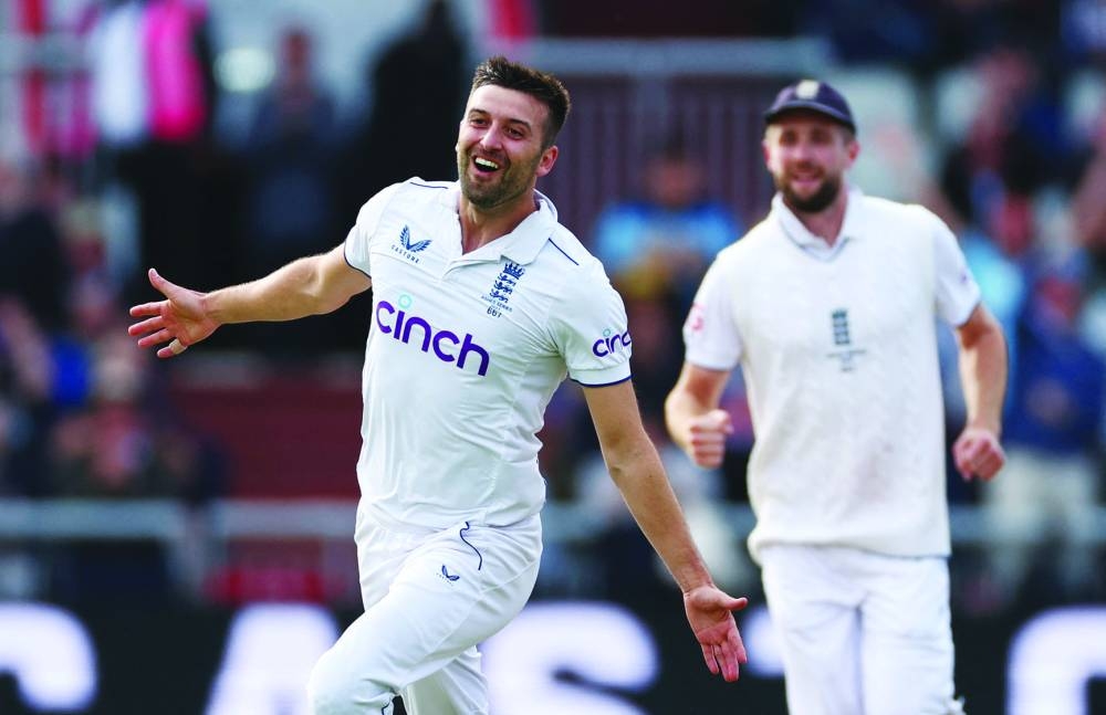 
Mark Wood celebrates taking the wicket of Australia’s Travis Head. (AFP) 