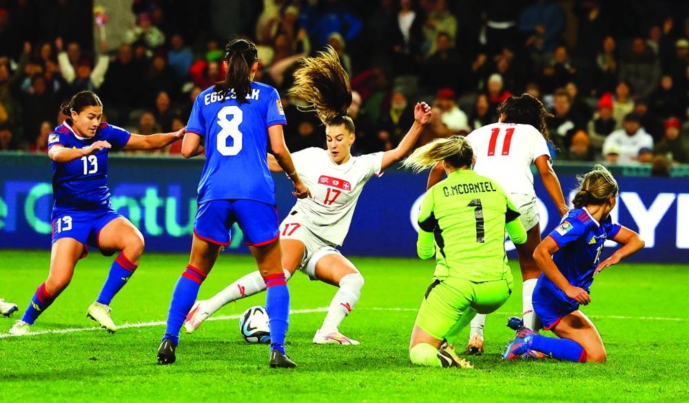 
Switzerland’s Seraina Piubel (centre) scores against Philippines in Dunedin. (Reuters) 