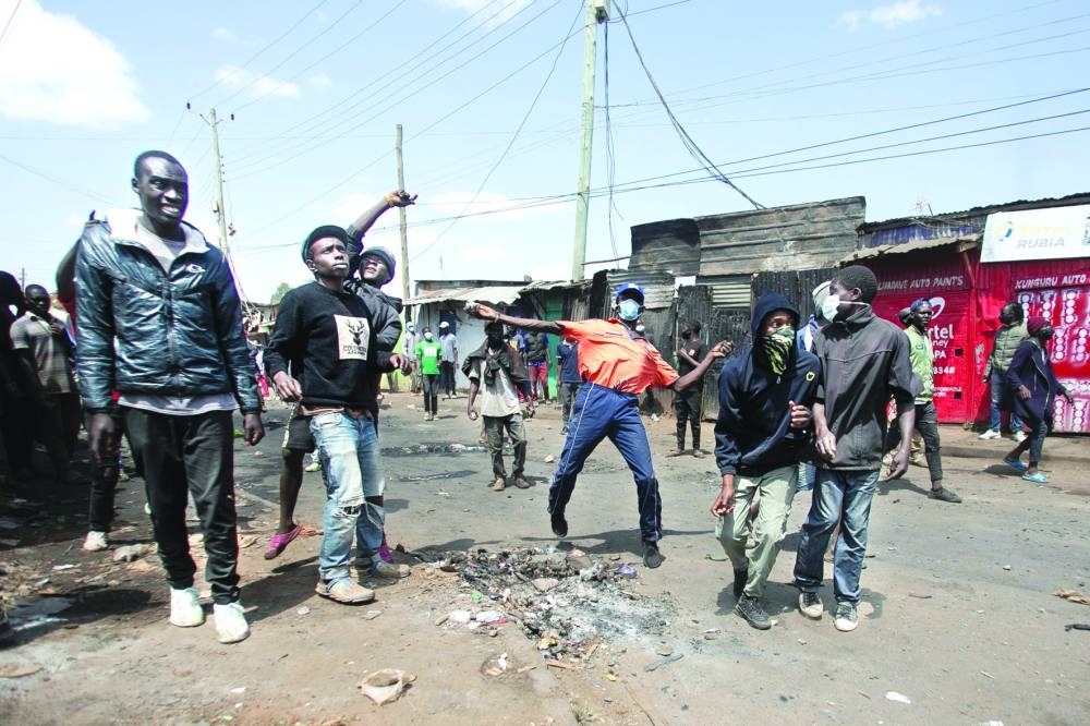 
Protesters throw rocks in the direction of police on the third day of confrontations between authorities and supporters of the Kenyan opposition during anti-government protests in Kibera, yesterday. 