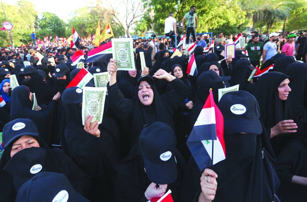 Supporters of Iraq's Hashed al-Shaabi (Popular Mobilisation) group take part in a protest denouncing the burning in Sweden of the Holy Qur'an book,  near Baghdad's Green Zone, Saturday.