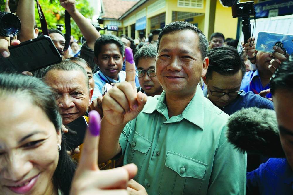 Hun Manet, commander of the Royal Cambodian Army and eldest son of Prime Minister Hun Sen, shows his finger after he casts his vote at a polling station in Phnom Penh on Sunday.