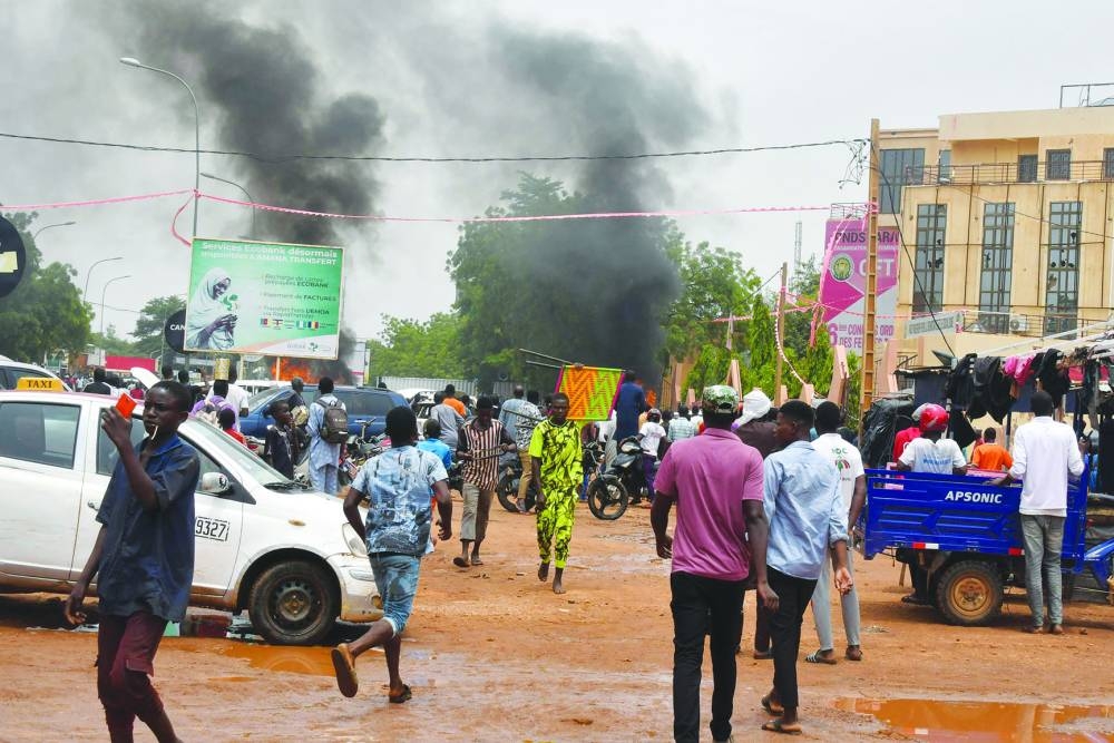 
A general view of billowing smoke as supporters of the Nigerien defence and security forces attack the headquarters of the Nigerien Party for Democracy and Socialism (PNDS), the party of overthrown President Mohamed Bazoum, in Niamey. 