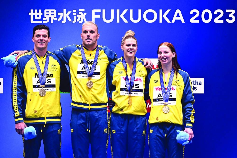 Gold medallists Australia pose during the medals ceremony for the mixed 4x100m freestyle relay at the World Aquatics Championships in Fukuoka, Japan, on Saturday. (AFP)