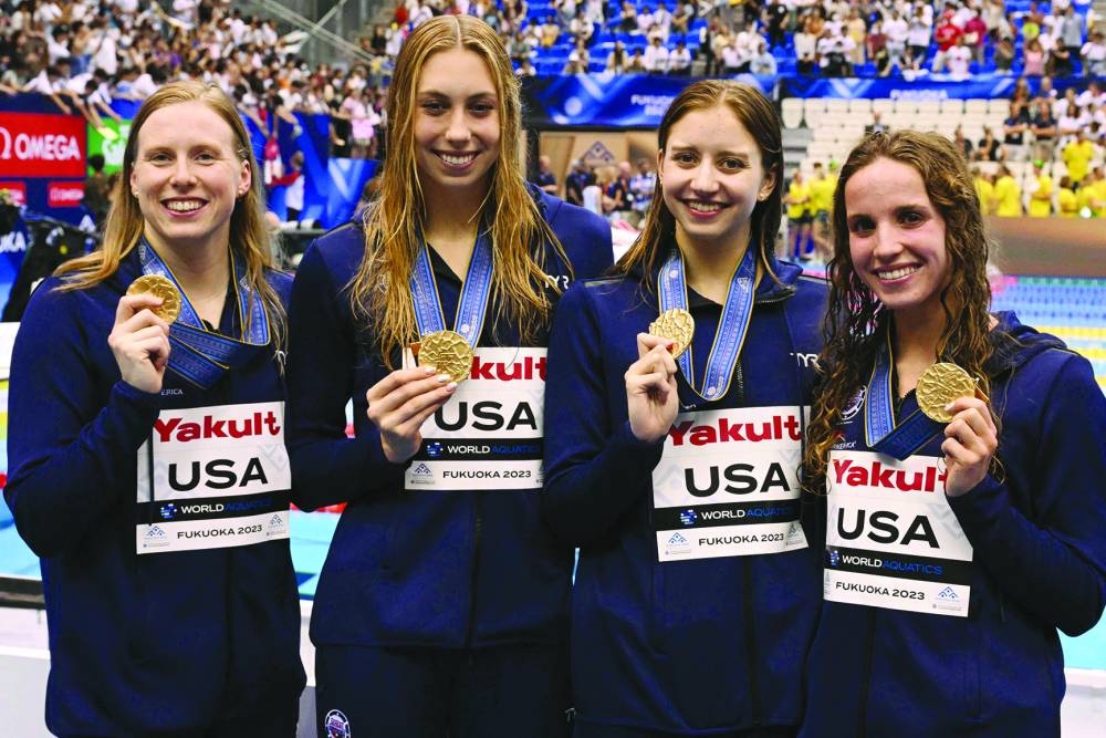 
From left: USA’s Lilly King, Gretchen Walsh, Kate Douglass and Regan Smith pose with their gold medal after winning the women’s 4x100m medley relay. (AFP) 
