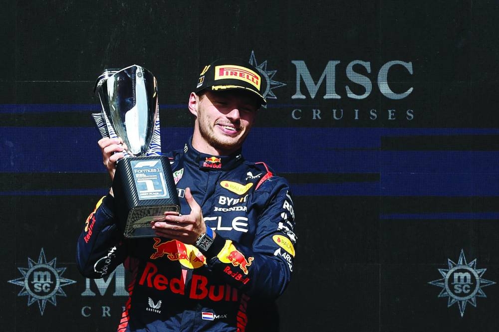 Red Bull Racing's Dutch driver Max Verstappen celebrates with his trophy  on the podium after winning  the Formula One Belgian Grand Prix at the Spa-Francorchamps Circuit in Spa on Sunday. (AFP)