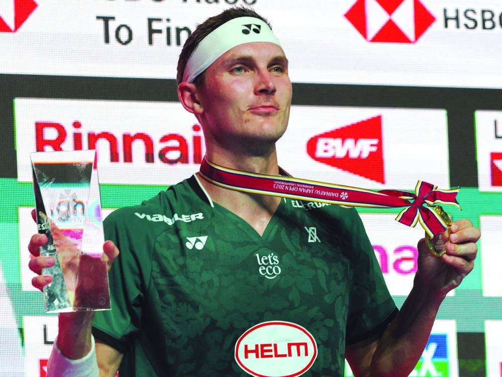 Viktor Axelsen of Denmark (left) and An Se-Young of South Korea celebrate after winning Japan Open titles in Tokyo on Sunday. (AFP)