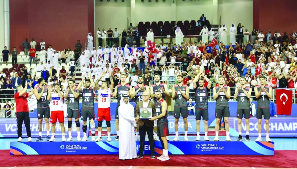 Turkiye captain Arslan Eksi receives the trophy from Qatar Volleyball Association president Ali Ghanem al-Kuwari after winning the Volleyball Challenger Cup 2023 at the Aspire Dome on Sunday.
