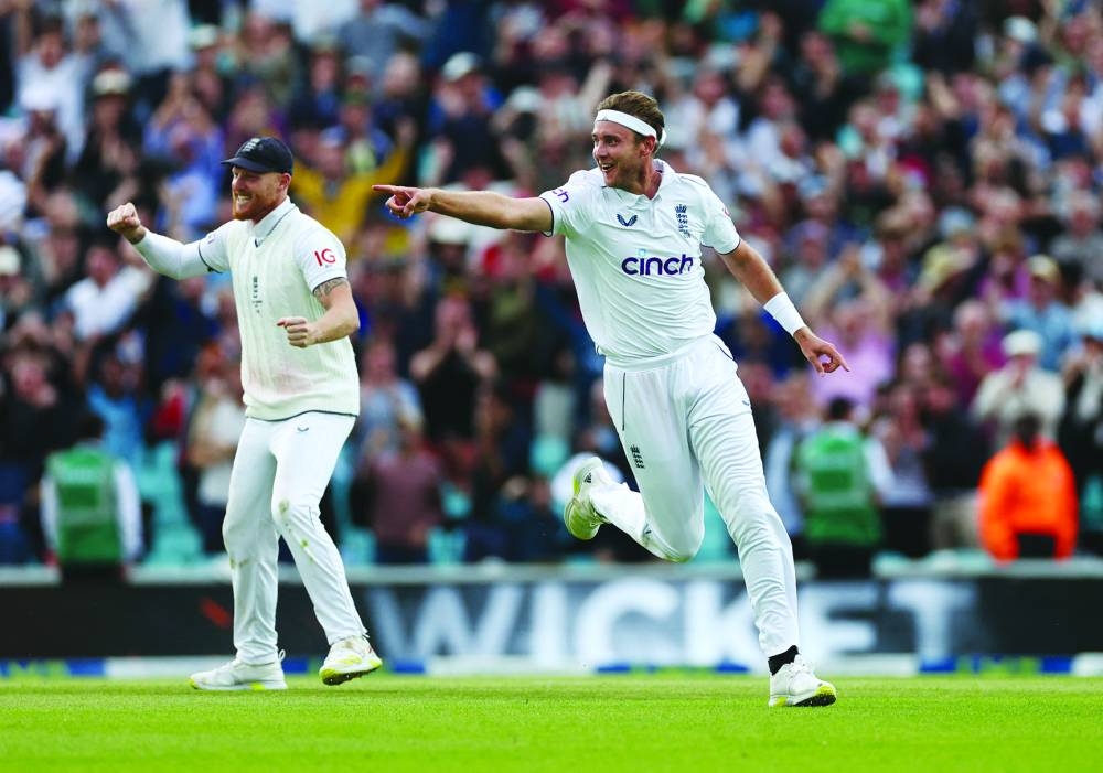 
England’s Stuart Broad celebrates with Ben Stokes after taking the wicket of Australia’s Todd Murphy during the fifth day of the final Ashes Test at the Oval yesterday. (Reuters) 