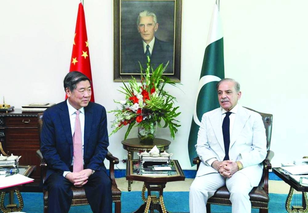 Pakistan Prime Minister Shehbaz Sharif and Chinese Vice-Premier He Lifeng during a meeting at the Prime Minister House in Islamabad on Monday. Right: Pakistan President Arif Alvi conferring the country’s second highest civilian award, Hilal-e-Pakistan, on the Chinese 
vice-premier at the President House.  (Reuters, AFP)