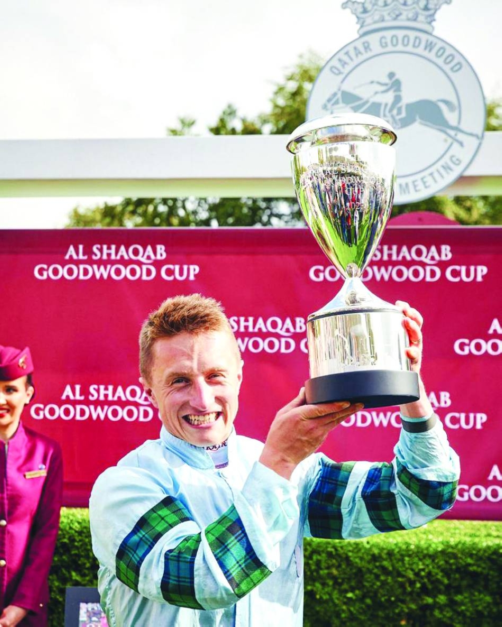 Jockey Tom Marquand celebrates with the Al Shaqab Goodwood Cup Stakes trophy on Tuesday.