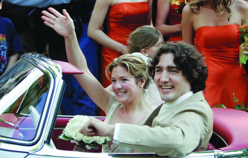 Newlyweds Justin Trudeau and Sophie Gregoire wave as they drive off in his father’s 1959 Mercedes 300SL following their wedding ceremony, in Montreal, on May 28, 2005. (Reuters)