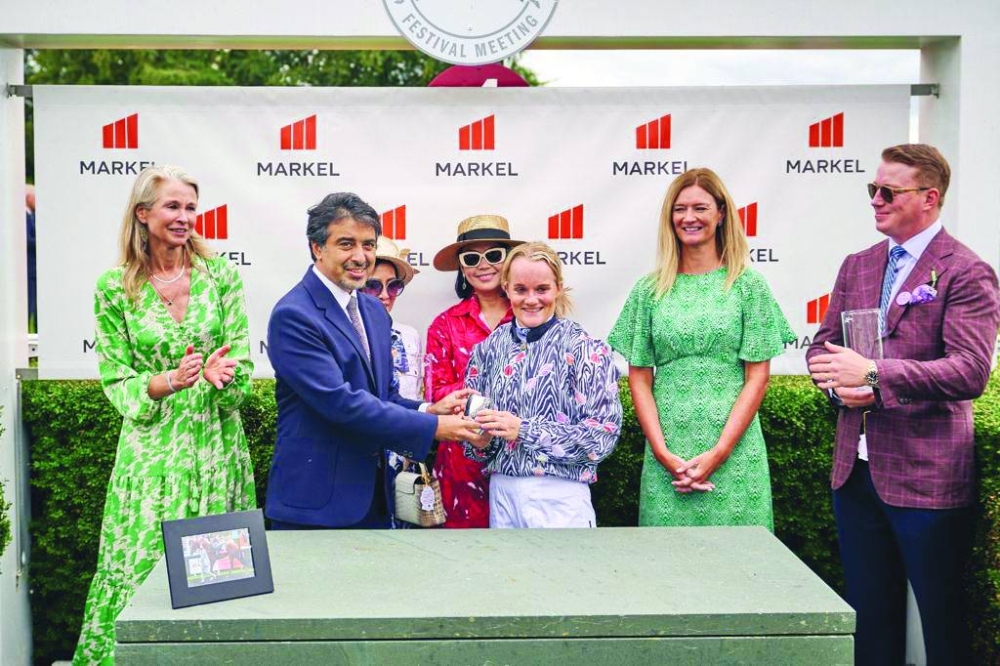 Fahad al-Sulaiti, CEO of Education Above All, presents a trophy to jockey Annabelle Hadden-Wight, who led Fosroc to Markel Magnolia Cup victory at the Qatar Goodwood Festival in United Kingdom on Friday.