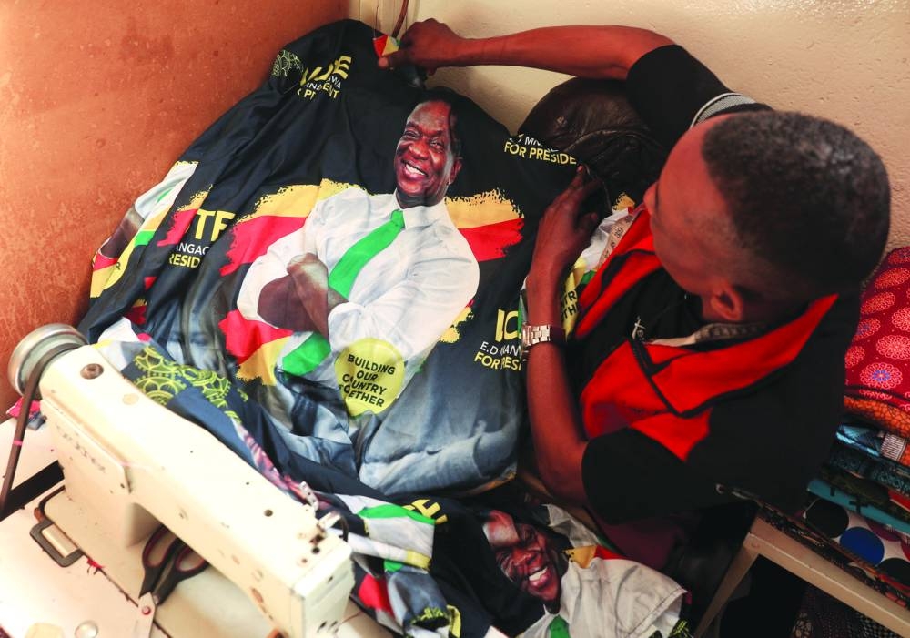 
Juda Zuze, a tailor, works on a piece of clothing with an image of Zimbabwe’s President Emmerson Mnangagwa. 