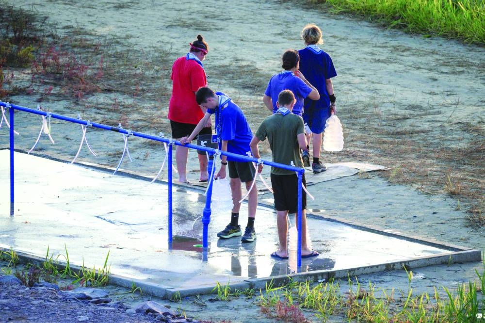 
Scouts fill up containers of water at the campsite of the World Scout Jamboree in Buan. 