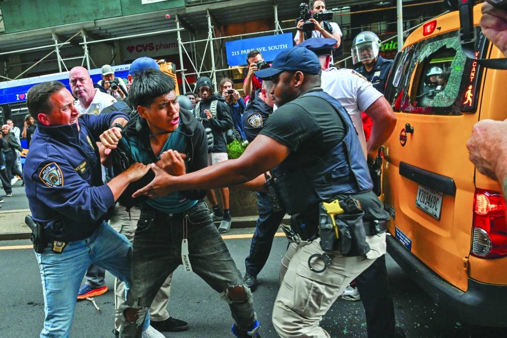 
Members of the NYPD respond to the disruptions caused by large crowds during a ‘giveaway’ event hosted by Cenat. 