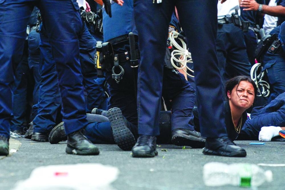 
Police officers detain a person after Kai Cenat’s ‘giveaway’ event grew chaotic. 