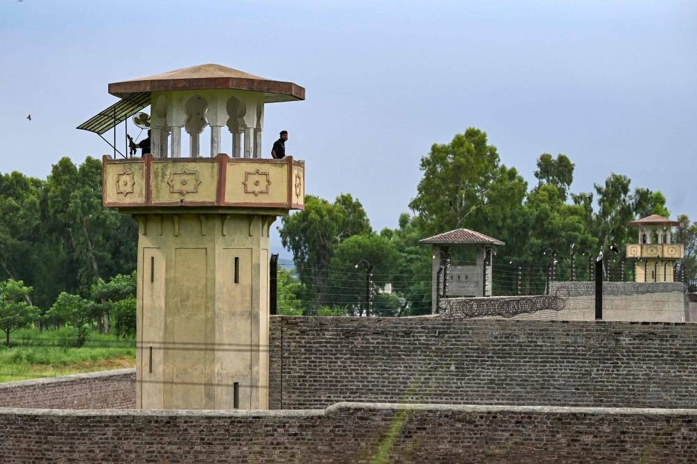 Policemen stand guard at the Attock prison post where Pakistan's former Prime Minister Imran Khan is being held for three years in Attock on August 6. Aamir QURESHI / AFP