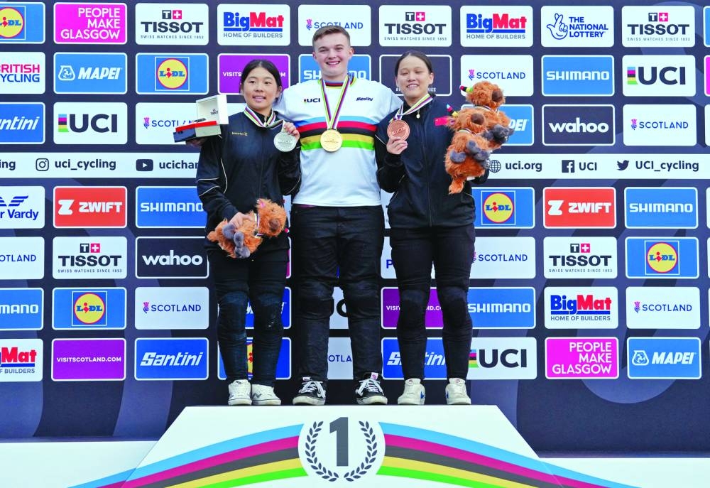 Hannah Roberts of the US celebrates on the podium with the gold medal after winning the BMX women’s park elite final alongside silver medalist China’s Sibei Sun and bronze medalist China’s Huimin Zhou at the UCI World Championships in Glasgow, Scotland, on Monday. (Reuters)