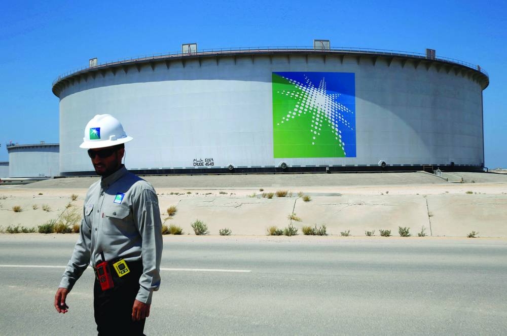
An Aramco employee walks near an oil tank at Saudi Aramco’s Ras Tanura oil refinery and oil terminal in Saudi Arabia. Aramco yesterday announced profits of $30.08bn for the second quarter, a sharp fall from the same period last year when prices surged after Russia invaded Ukraine. 