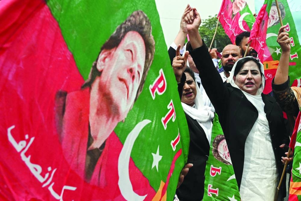 
Lawyers supporting former prime minister Imran Khan denouncing his arrest during a protest outside the Lahore High Court in Lahore yesterday. Right: A police officer stands guard on the watch tower of the district jail in Attock, where the former prime minister is imprisoned. (AFP, Reuters) 