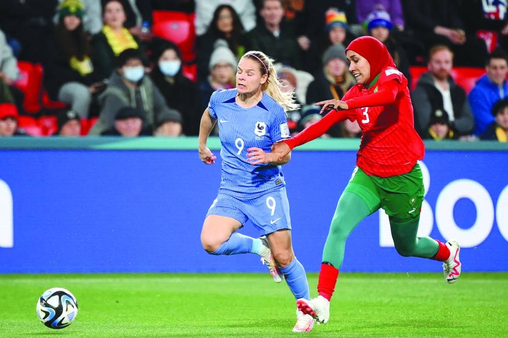 
France’s Eugenie Le Sommer (left) and Morocco’s Nouhaila Benzina vie for the ball during the World Cup round of 16 match. (AFP) 
