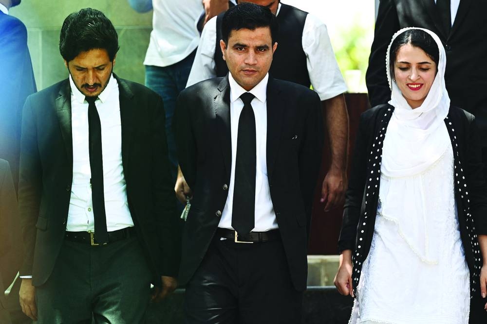 
Naeem Haider Panjutha (centre), lawyer of former prime minister Imran Khan flanked by other team members, leaves the Islamabad High Court building after filing petition against Khan’s conviction in Islamabad yesterday. (AFP) 