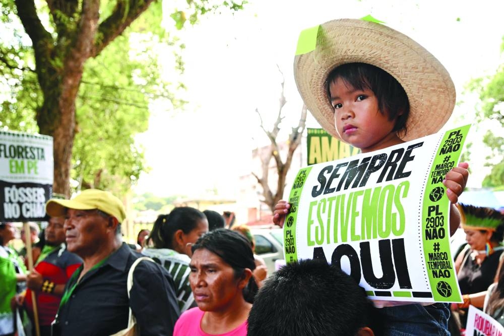 
Right: Indigenous people from Amazon countries and members of social movements take part in the March of the Peoples of the Earth for the Amazon in Belem. 