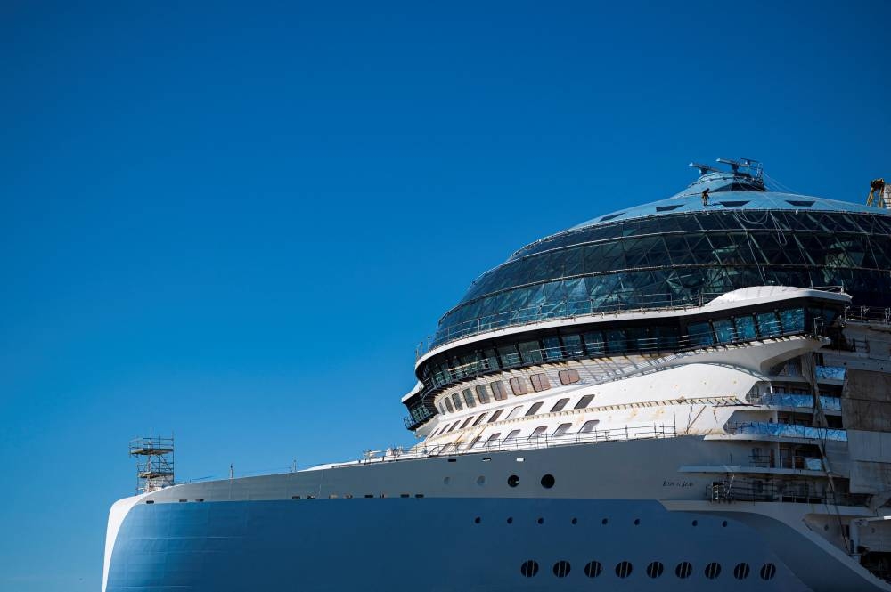 A photo taken on May 30, 2023 shows a worker on a roof of the Royal Caribbean's new ship 'Icon of the Seas' which is currently under construction at the Turku shipyard in Finland's southwest coast.  AFP