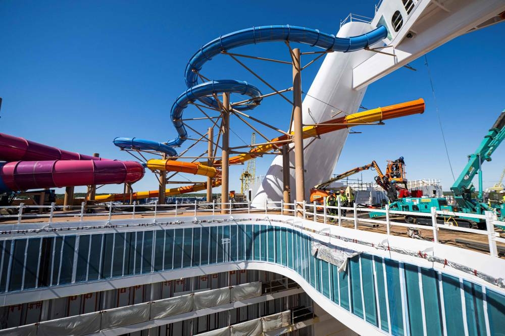 Workers walk at the construction site on a deck of the Royal Caribbean's new ship 'Icon of the Seas' at the Turku shipyard in Finland's southwest coast on May 30, 2023. AFP