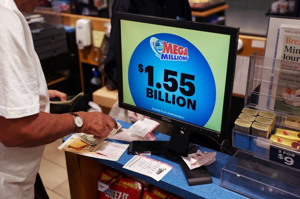 The display in a store shows the Mega Millions lottery jackpot at $1.55-billion in New York City.  REUTERS