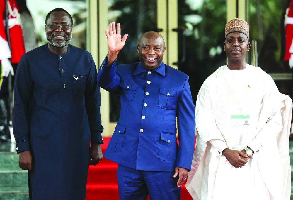 
President of Economic Community of West African States Commission, Omar Touray (left), Burundi’s President Evariste Ndayishimiye and Nigeria’s Minister of Foreign Affairs, Adamu Ibrahim Lamuwa, pose for a photograph at the Economic Community of West African States (ECOWAS) Head of States and Government extraordinary session in Abuja yesterday. 