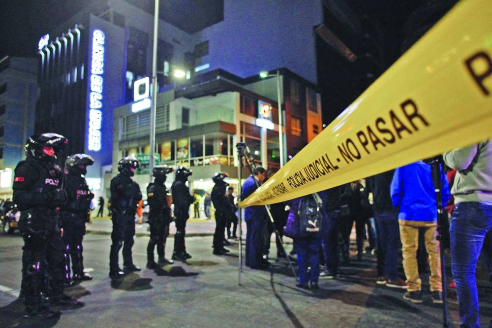 
Police officers stand guard outside the hospital where Villavicencio was taken after being shot at a rally in Quito. 
