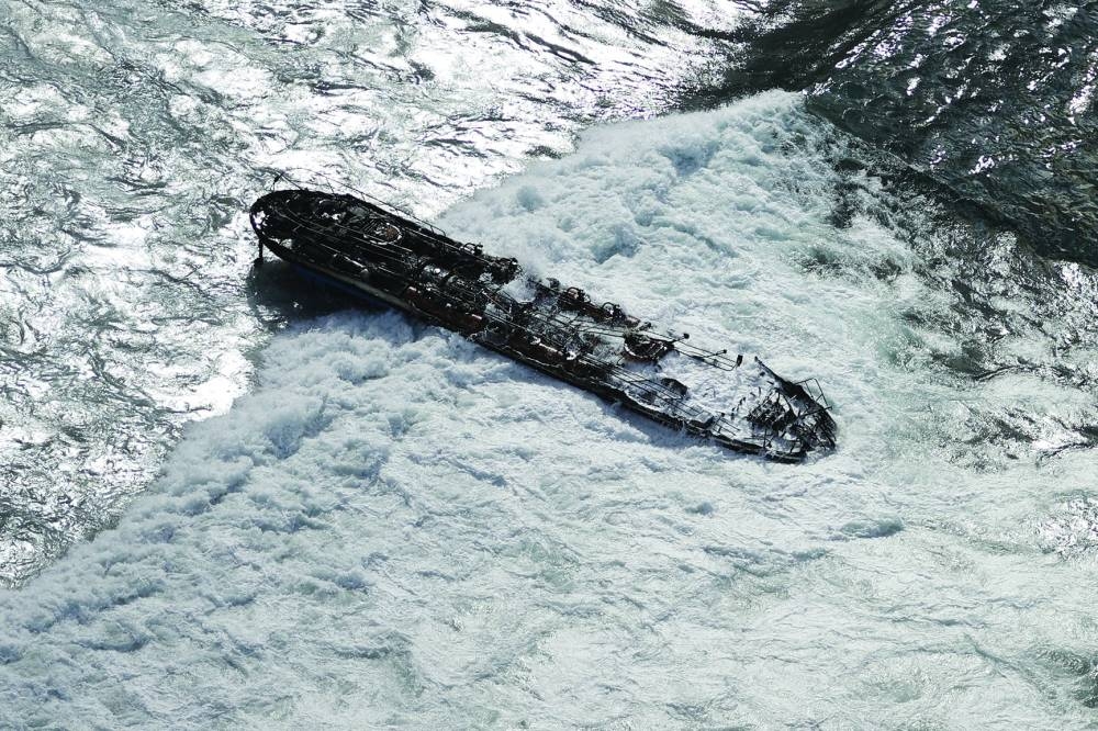 
A burnt-out boat is seen in the waters fronting Lahaina. 
