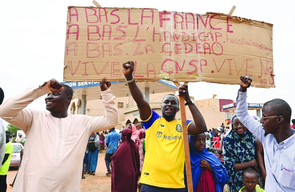 Supporters of Niger’s National Council for the Safeguard of the Homeland (CNSP) hold Niger and Russian flags as they gather for a demonstration in Niamey near a French air base in Niger.