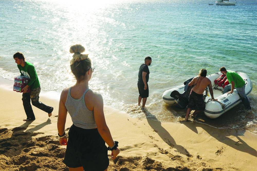 
Mercy Worldwide volunteers unload supplies to West Maui towns affected by wildfires destroyed homes and businesses at Black Rock Beach in Lahaina. 