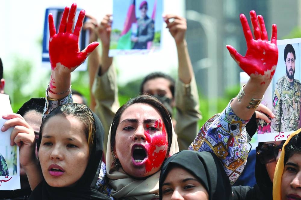 Afghans carry placards and shout slogans during a demonstration against the Taliban government in Islamabad. (AFP)