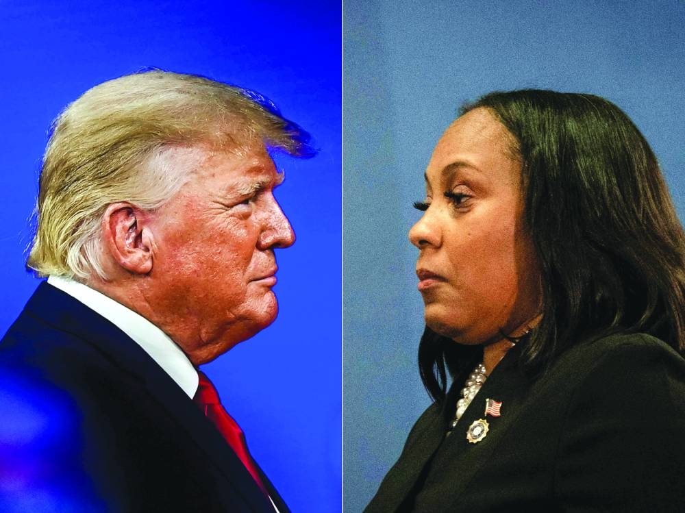 Former US President Donald Trump in Orlando, Florida, on February 26, 2022 and Fulton County District Attorney Fani Willis on August 14, 2023, in Atlanta, Georgia.