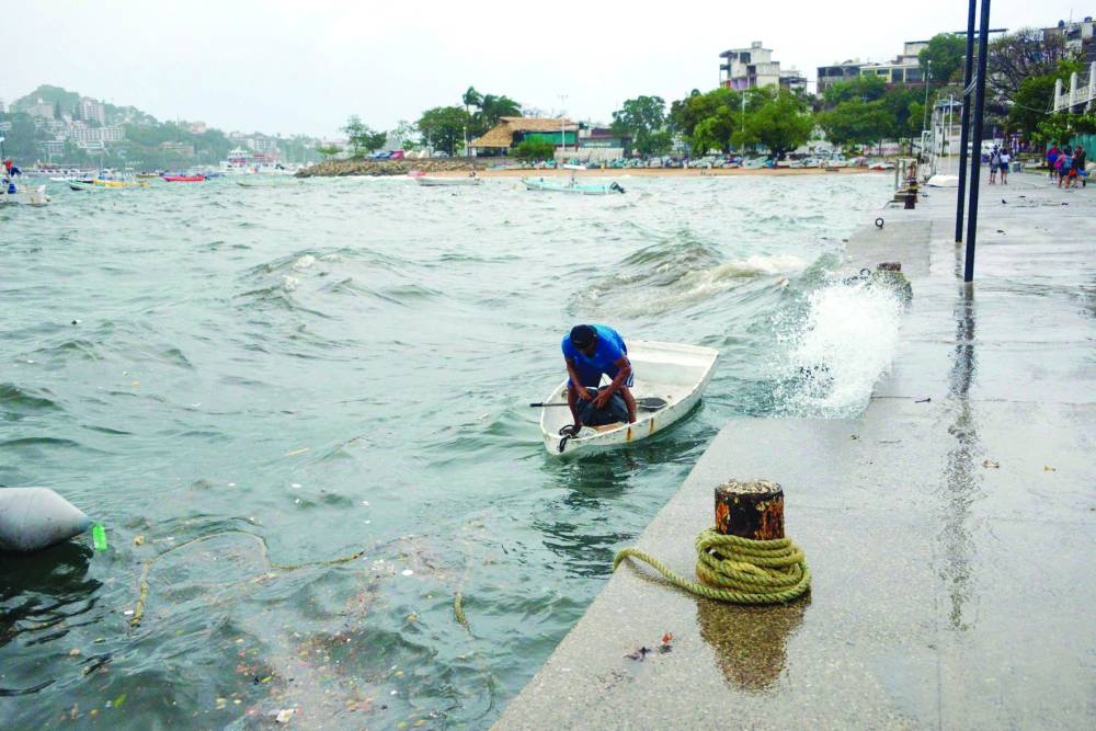 A man moors his boat in Acapulco, Mexico, following the passage of Tropical Storm Hilary.