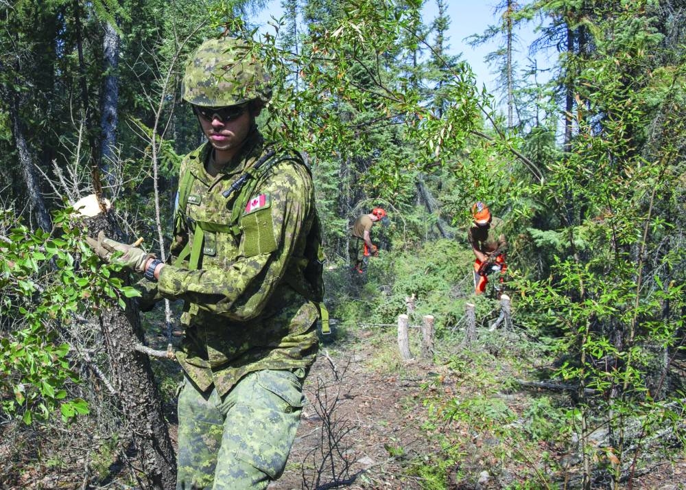 
In this undated image released by the Joint Task Force North, members of the Canadian Armed Forces construct firebreaks to fight wildfires in the vicinity of Yellowknife and Dettah, Northwest Territories, Canada. 
