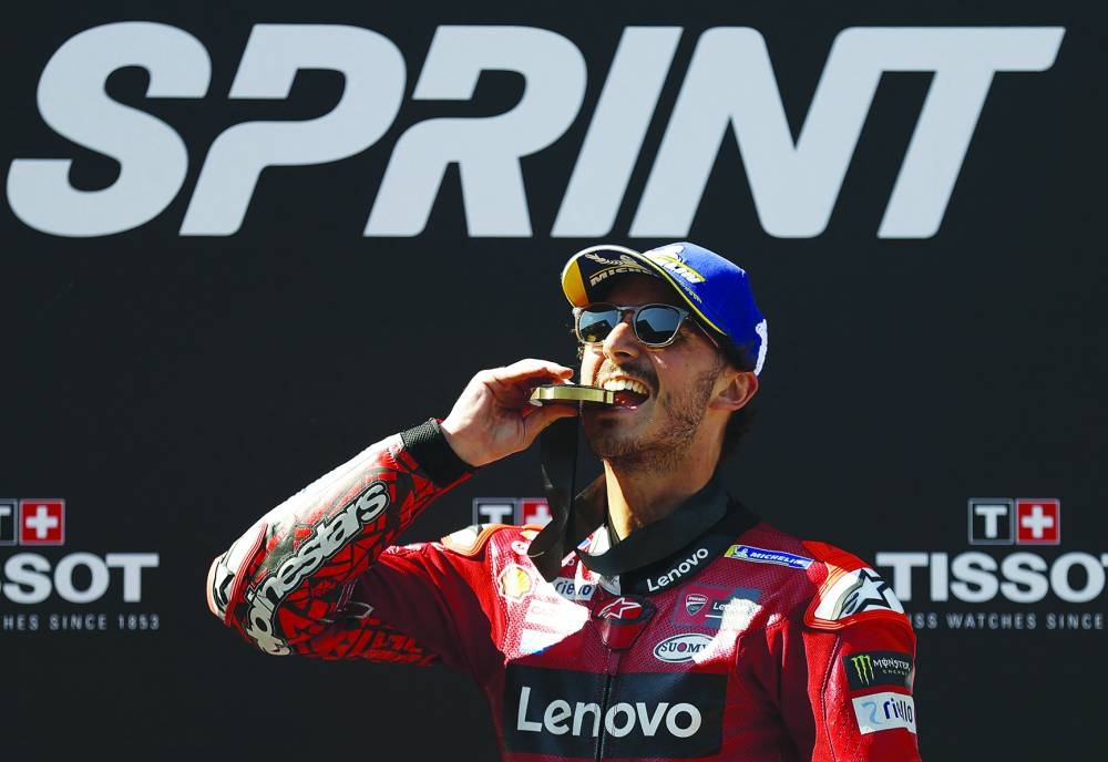 Ducati Lenovo Team Italian rider Francesco Bagnaia celebrates with his medal on the podium after winning the sprint race at the Red Bull Ring race track in Spielberg, Austria, on Saturday, ahead of the MotoGP Austrian Grand Prix. (AFP)