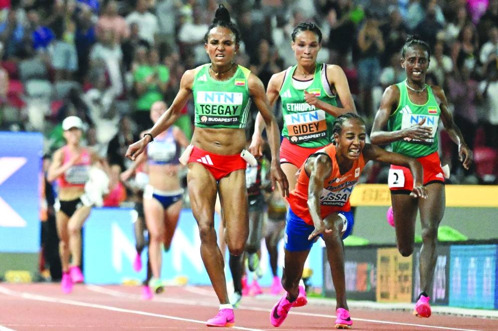 Netherlands’ Sifan Hassan falls while running past Ethiopia’s Gudaf Tsegay (left), Letesenbet Gidey and Ejgayehu Taye during the women’s 10,000m final at the World Athletics Championships in Budapest on Saturday. (AFP)