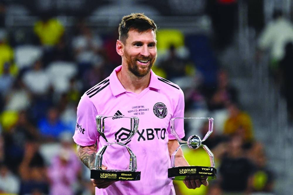 Inter Miami's Argentine forward Lionel Messi poses with the awards for Best Player and Top Scorer after Inter Milan won the Leagues Cup final against Nashville SC at Geodis Park in Nashville, Tennessee. (AFP)