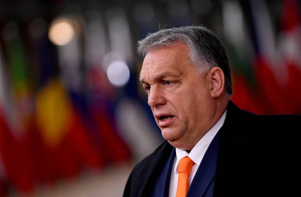 FILE PHOTO: Hungarian Prime Minister Viktor Orban speaks as he arrives for an EU summit in Brussels, Belgium December 10, 2020. John Thys/Pool via REUTERS/File Photo