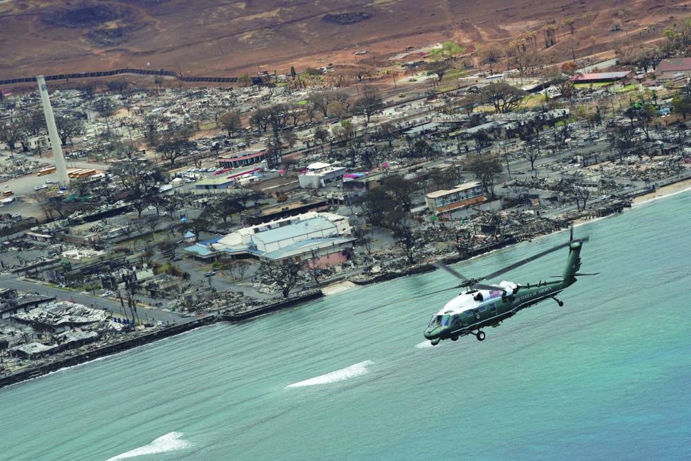 
Right: Biden, aboard Marine One, inspects the fire-ravaged town of Lahaina on the island of Maui in Hawaii. 