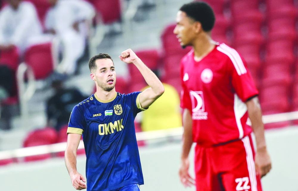 AGMK’s Ruben Sanchez (left) celebrates after scoring against Al Arabi during the playoff match at the Al Thumama Stadium. PICTURE: AFC/ Mohamed Farag