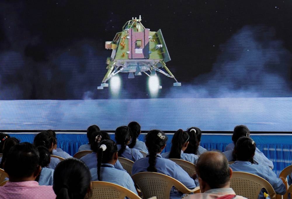 People watch a live stream of Chandrayaan-3 spacecraft's landing on the moon, inside an auditorium of Gujarat Science City in Ahmedabad, India. REUTERS