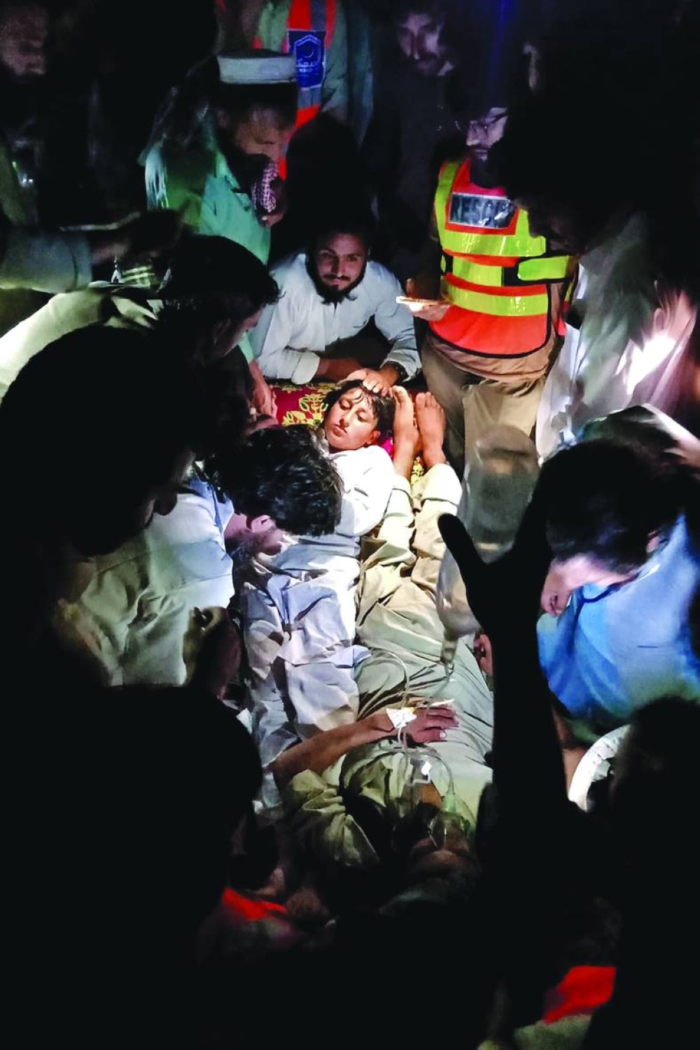 
Victims receiving first aid after being rescued from a chairlift that plunged into a ravine in Pashto village of mountainous Khyber Pakhtunkhwa province. Right: Survivors of the cable car accident speak to a professor at their school in the village yesterday. (Reuters, AFP) 